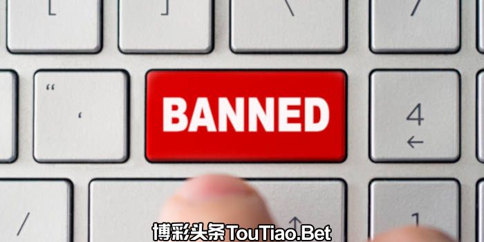 Button on computer keyboard with the word banned on it